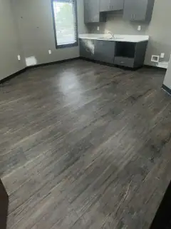 Same office after the final clean, with a clear floor and clean cabinets