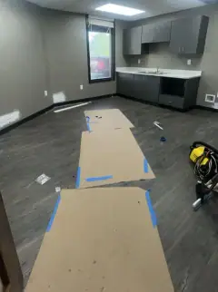 Office build-out with floor protection paper and construction dust