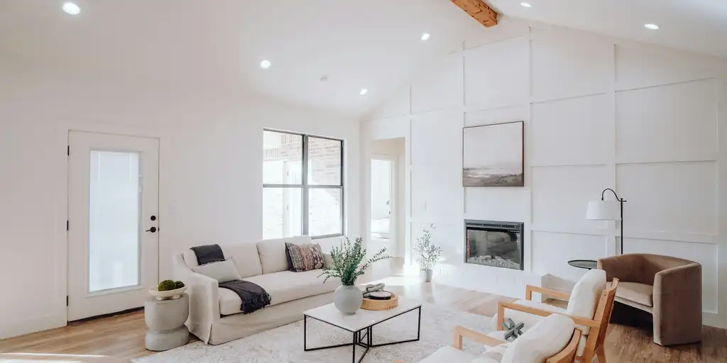 Bright living room with vaulted ceiling and fireplace